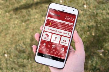 hand holding a phone with UNLV app displaying
