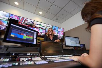 student and woman working in TV news production area