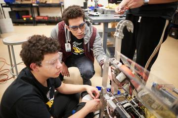 Students Adi Pahima and Magnus Yuen build and programing their robot.